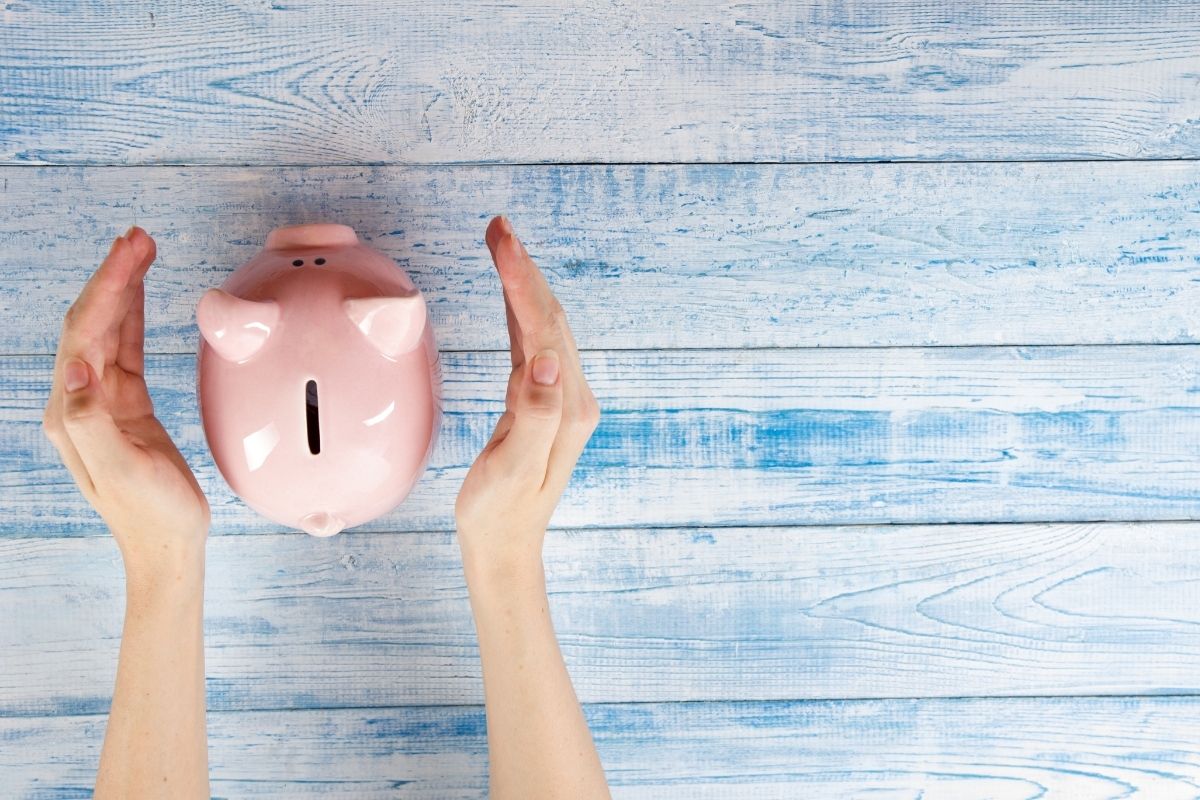 Pink piggy bank with blue background