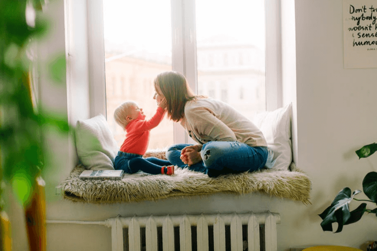 A woman and child sat near a window
