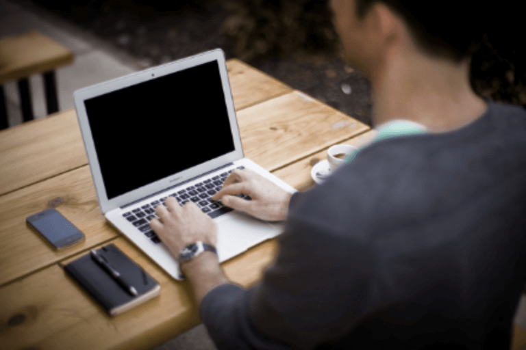 Man typing on laptop