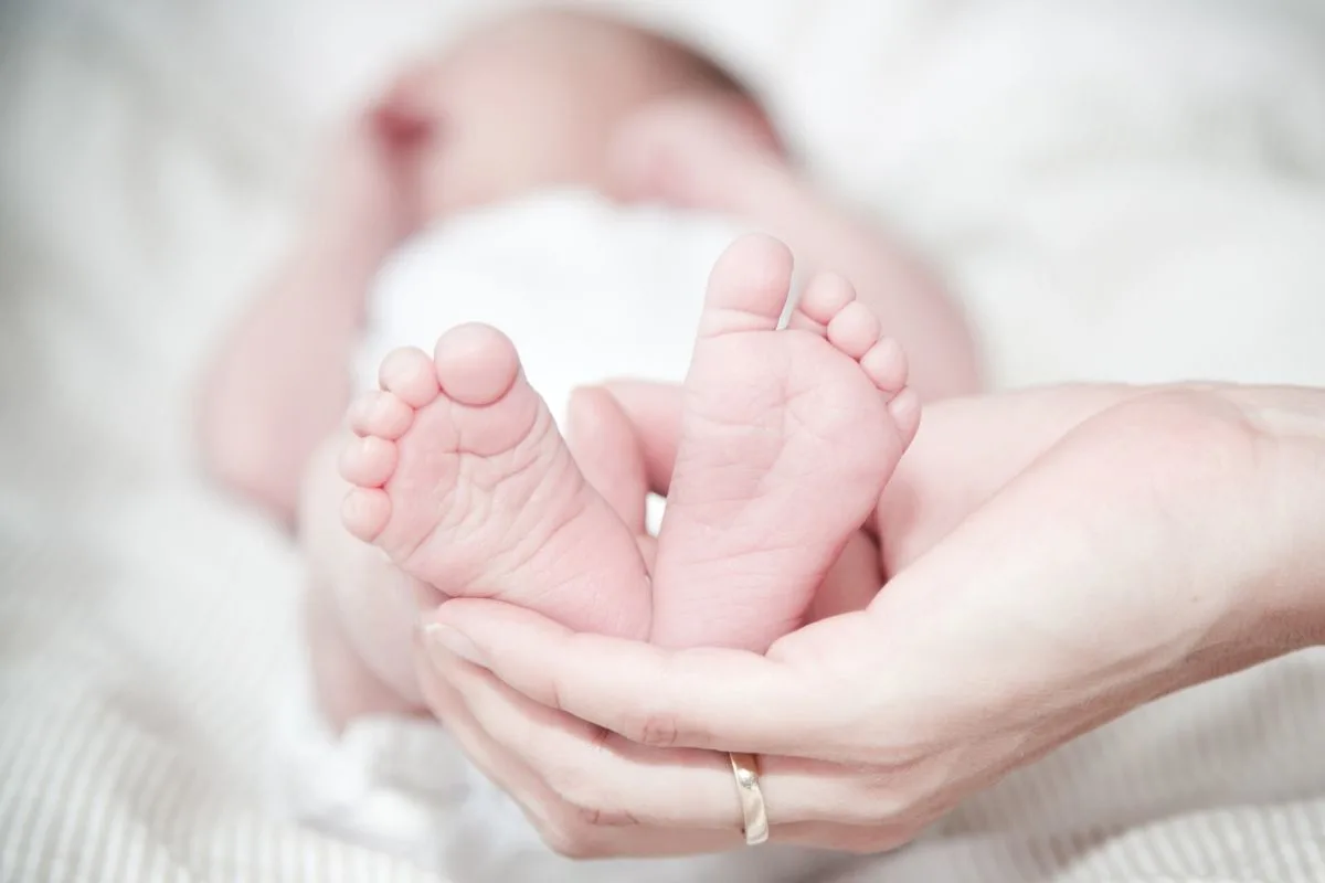 baby's feet in mums hands