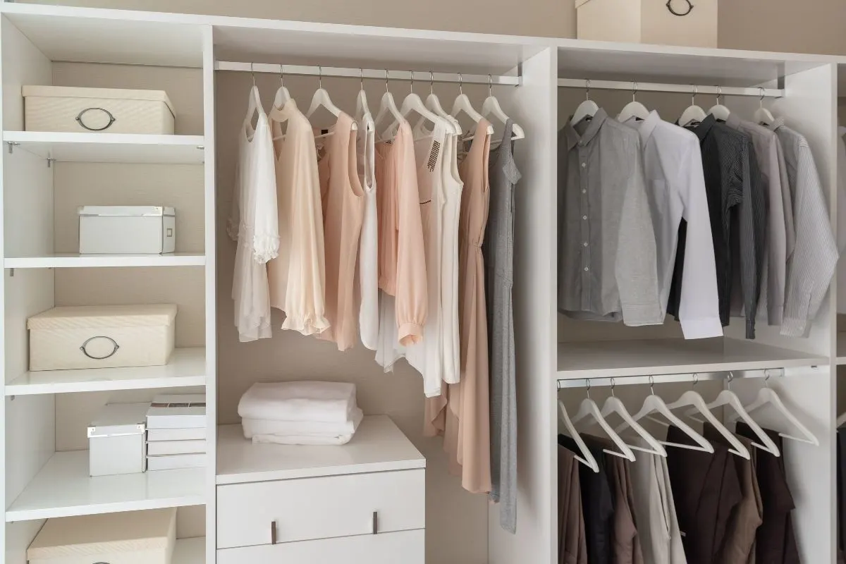 White wardrobe with clothes hung up