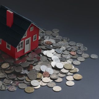 Red small house sat on coins