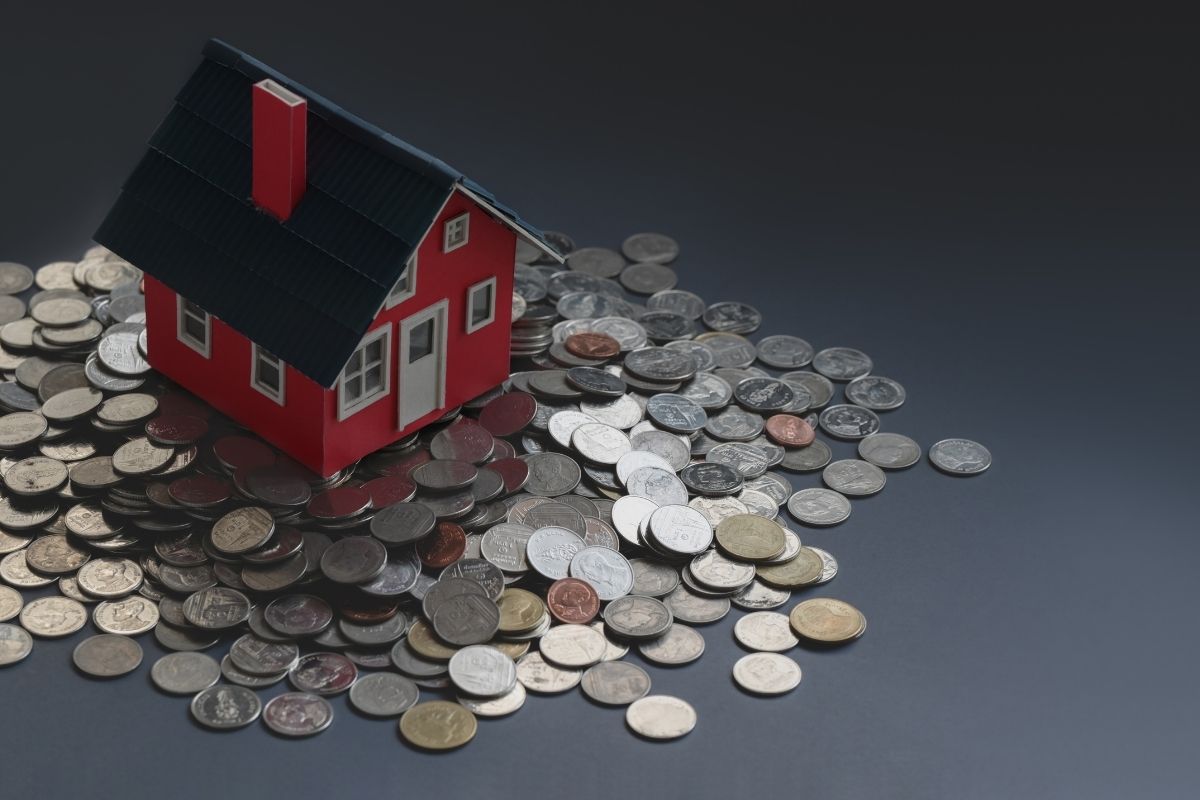 Red small house sat on coins