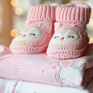 Blankets with pink booties on top