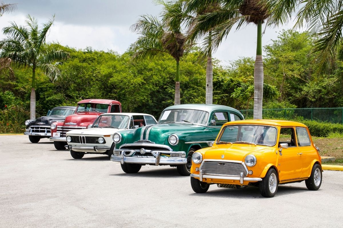 Four coloured cars parked next to each other
