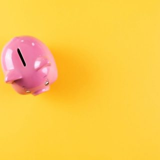Yellow background with a pink piggy bank