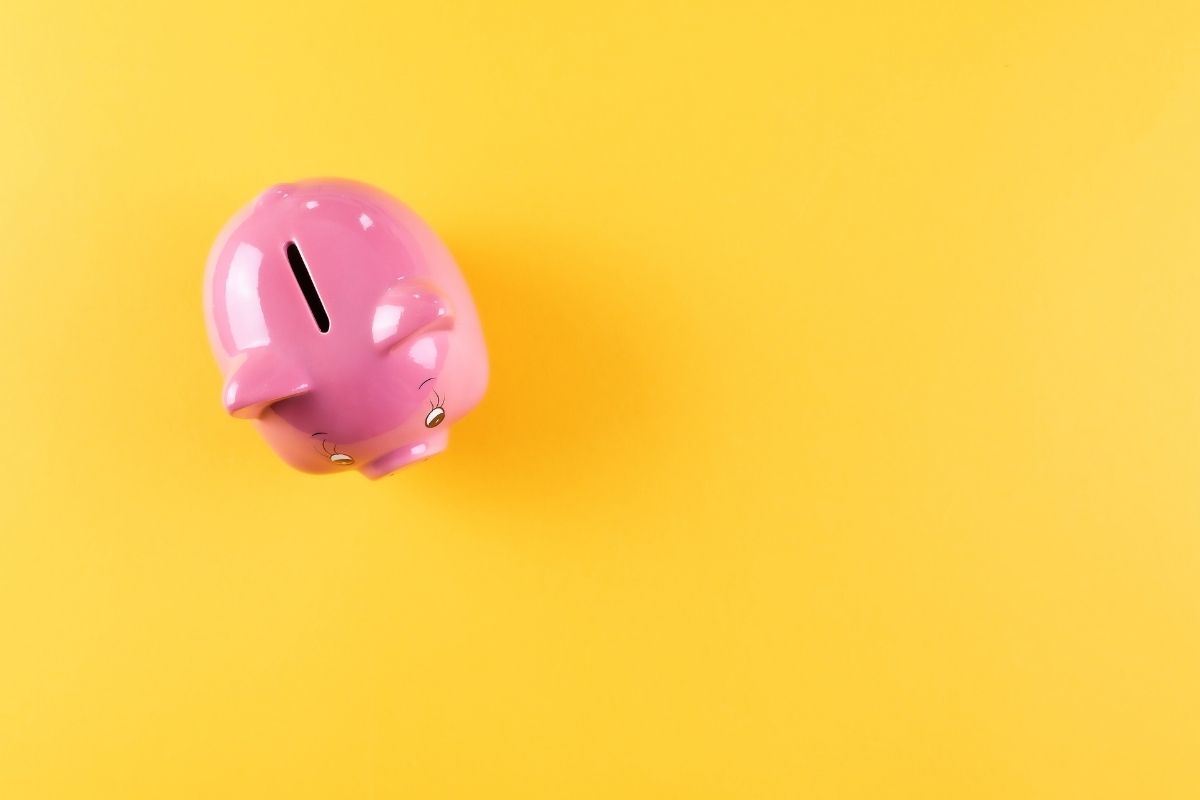 Yellow background with a pink piggy bank