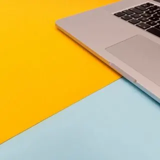 Yellow and blue desk with a laptop on