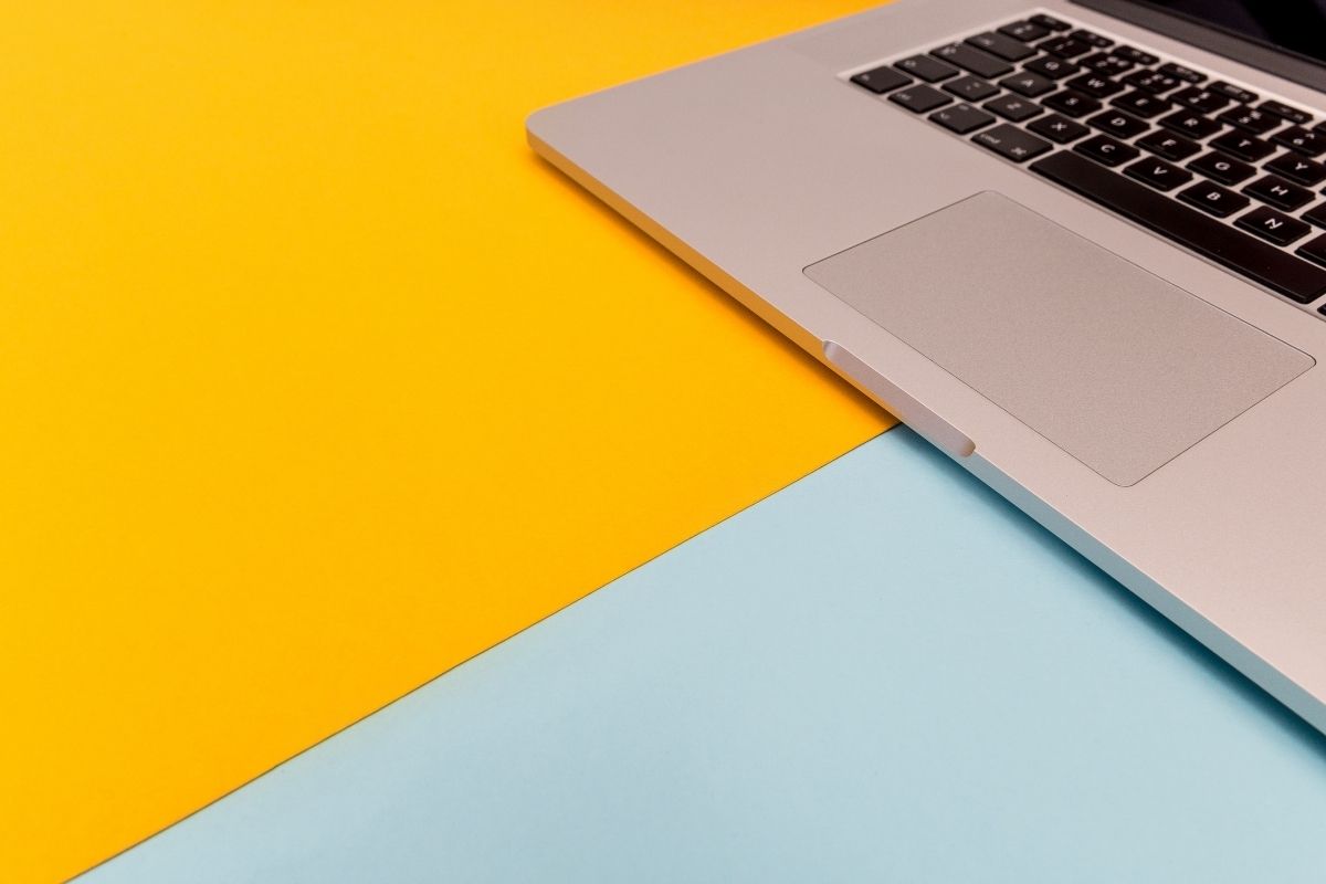 Yellow and blue desk with a laptop on